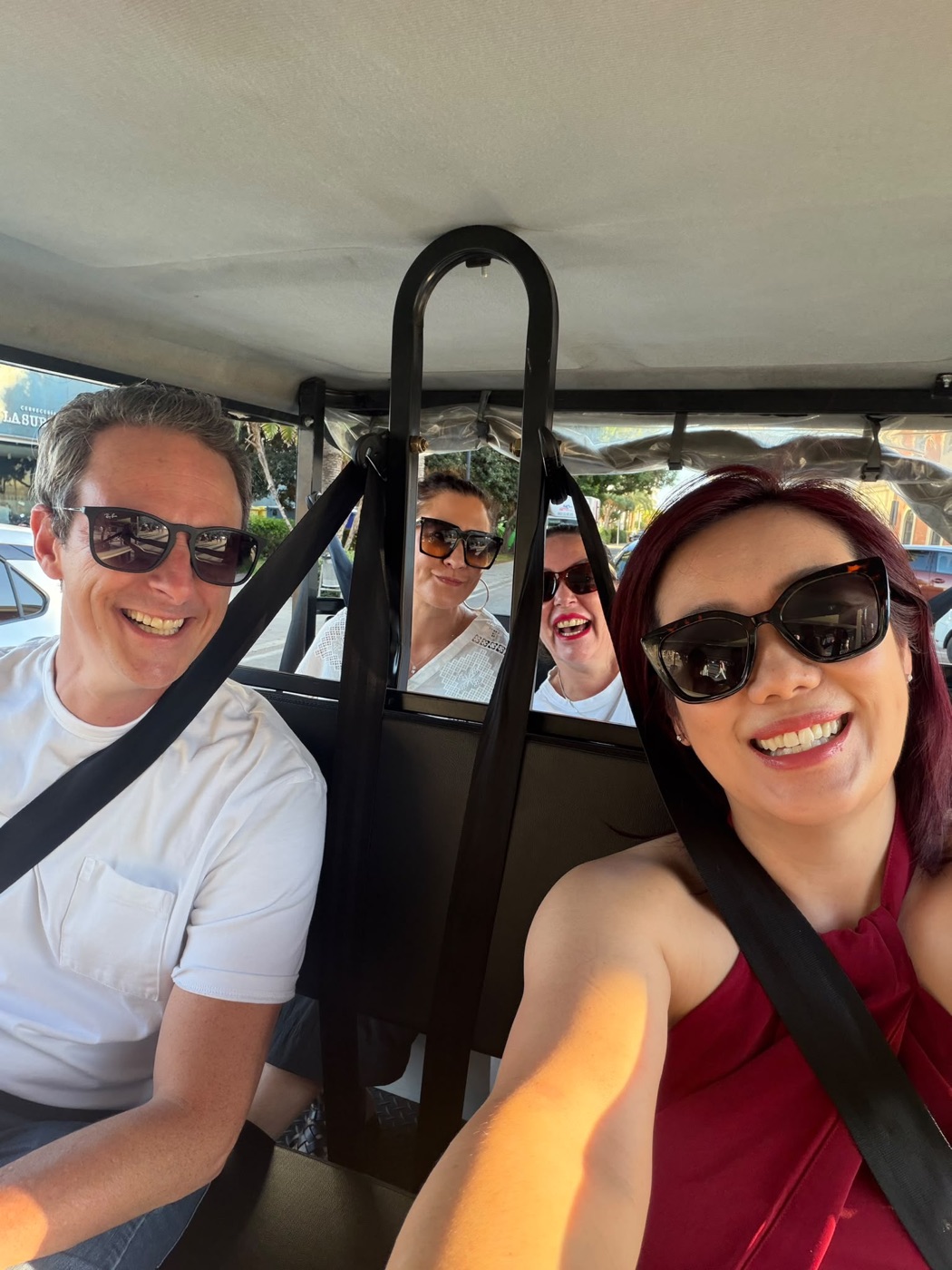 Attendees laughing on an open-top ride through Alicante